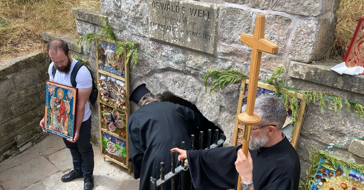 Orthodox clergy raise the wooden cross and bless the waters at St Oswald’s Well, Oswestry, during the pilgrimage